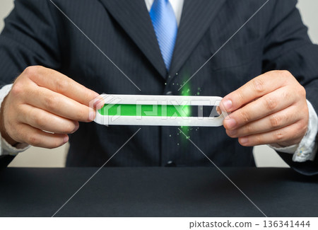 A businessman holds a filling progress bar scale. Productivity, income level. Visual story about performance tracking and revenue growth. Business success and KPI measurement concept for planning. 136341444
