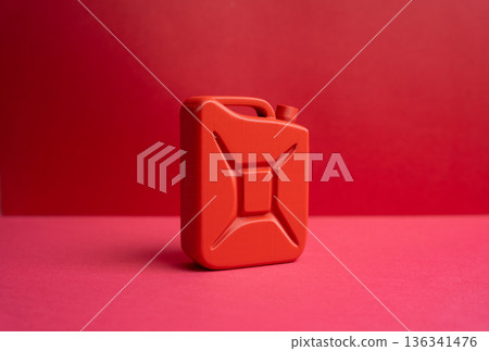 Red fuel canister. Gasoline or diesel. Fuel quality and price. Energy cost theme highlighting price volatility, supply concerns, and consumer awareness about fuel storage and transport safety Red fuel canister. Gasoline or diesel. Fuel quality and price. Energy cost theme highlighting price volatility, supply concerns, and consumer awareness about fuel storage and transport safety 136341476