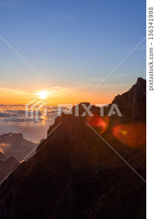 Cliff ridge at sunrise on Pico do Arieiro Madeira Portugal, glowing cloud ocean Cliff ridge at sunrise on Pico do Arieiro Madeira Portugal, glowing cloud ocean 136341998