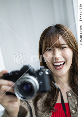 A woman with a camera A woman with a camera 136342116