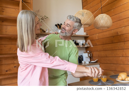 Smiling couple dancing during leisure time Smiling couple dancing during leisure time 136342852