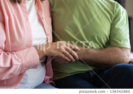 Senior couple holding hands showing love and support Senior couple holding hands showing love and support 136342860