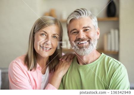 Happy couple looking at camera during home leisure 136342949