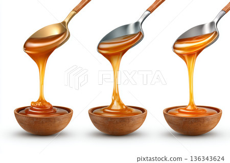 Caramel sauce wooden bowl metal spoon sweet dessert golden syrup liquid swirl closeup food sticky texture rich topping flowing stream 136343624