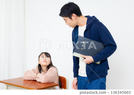 Elementary school student and teacher in classroom Elementary school student and teacher in classroom 136345003
