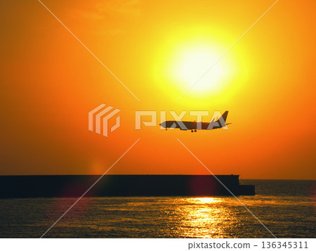 Sunset and airplane Sunset and airplane 136345311
