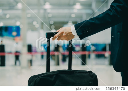 A business traveler pulling a suitcase. Photo courtesy of Kansai International Airport (KIX) A business traveler pulling a suitcase. Photo courtesy of Kansai International Airport (KIX) 136345470