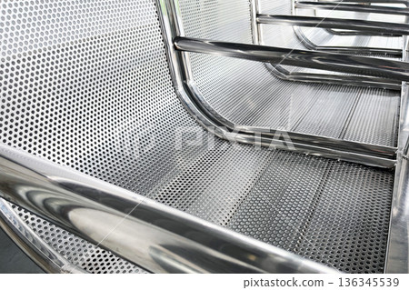 perforated stainless steel waiting bench in public transit station close up perforated stainless steel waiting bench in public transit station close up 136345539