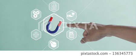 A hand points to a horseshoe magnet icon representing lead generation and customer attraction, surrounded by business strategy icons for marketing and sales growth concepts 136345773