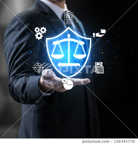 A businessman holding a glowing shield with scales of justice, representing legal protection, corporate governance, and business ethics in a digital environment A businessman holding a glowing shield with scales of justice, representing legal protection, corporate governance, and business ethics in a digital environment 136345776