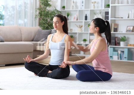 Private teacher teaching yoga at home 136346013