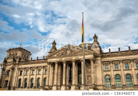 Berlin, germany, august 12, 2023. Reichstag building, home of german parliament bundestag, with its classical facade under a cloudy sky in berlin, germany Berlin, germany, august 12, 2023. Reichstag building, home of german parliament bundestag, with its classical facade under a cloudy sky in berlin, germany 136346073
