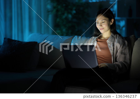 Asian woman using personal computer in the night at home Asian woman using personal computer in the night at home 136346237