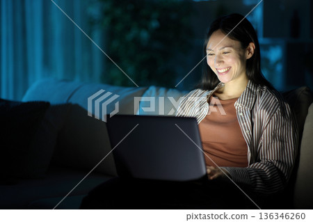 Happy asian woman using personal computer in the night 136346260