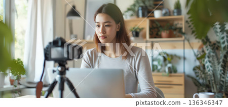 Young woman recording online video lesson at home office Young woman recording online video lesson at home office 136346347