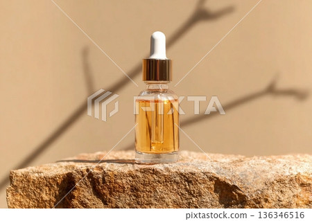 A cosmetic packaging mockup showing a clear serum bottle resting on a rock, set against beige backdrop for a clean and elegant aesthetic. A cosmetic packaging mockup showing a clear serum bottle resting on a rock, set against beige backdrop for a clean and elegant aesthetic. 136346516
