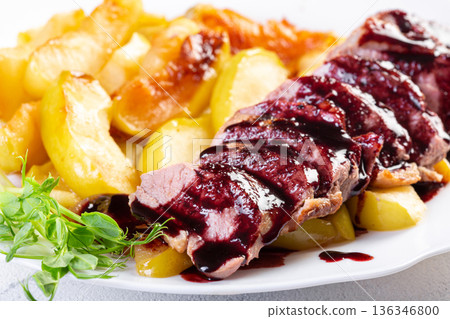 Duck breast with apples and sauce on plate Duck breast with apples and sauce on plate 136346800