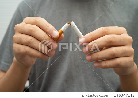 Man holding cigarette, no smoking. 136347112