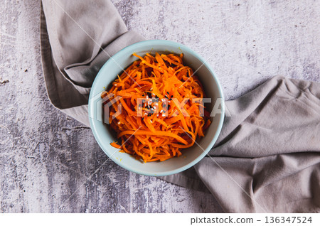 Close up of korean carrots with sesame seeds in a bowl on the table top view 136347524