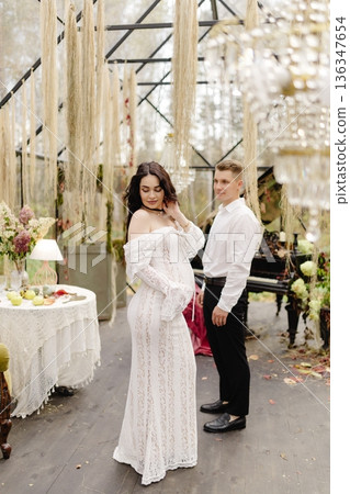 Pregnant woman and man celebrating maternity in greenhouse 136347654