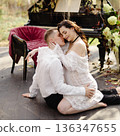 Romantic couple embracing near outdoor piano with chandelier 136347655