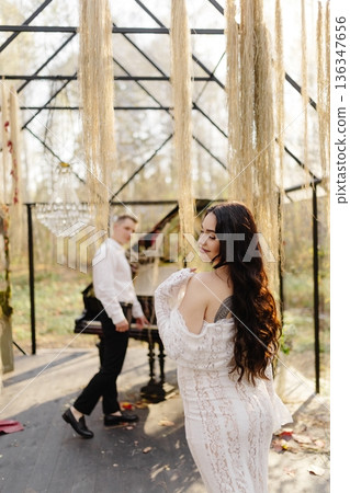 Romantic couple enjoying outdoor wedding music in bohemian gazebo Romantic couple enjoying outdoor wedding music in bohemian gazebo 136347656