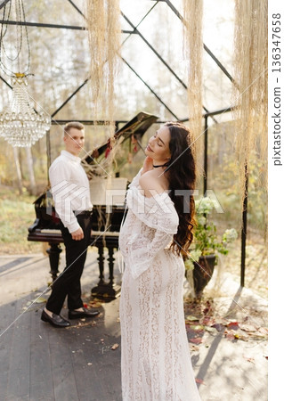 Expecting couple celebrating new life in greenhouse garden Expecting couple celebrating new life in greenhouse garden 136347658