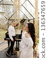 Expecting couple celebrating maternity in elegant greenhouse 136347659