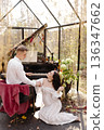 Pregnant couple playing piano celebrating love and new family 136347662