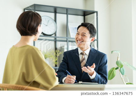 A businessman selling to a middle-aged woman A businessman selling to a middle-aged woman 136347675