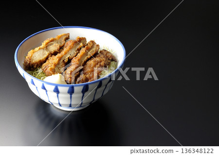 Mayonnaise and fried chicken rice bowl photographed against a black background 136348122