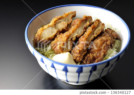 Mayonnaise and fried chicken rice bowl photographed against a black background Mayonnaise and fried chicken rice bowl photographed against a black background 136348127