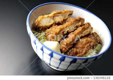 Mayonnaise and fried chicken rice bowl photographed against a black background Mayonnaise and fried chicken rice bowl photographed against a black background 136348128