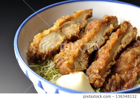 Mayonnaise and fried chicken rice bowl photographed against a black background Mayonnaise and fried chicken rice bowl photographed against a black background 136348132