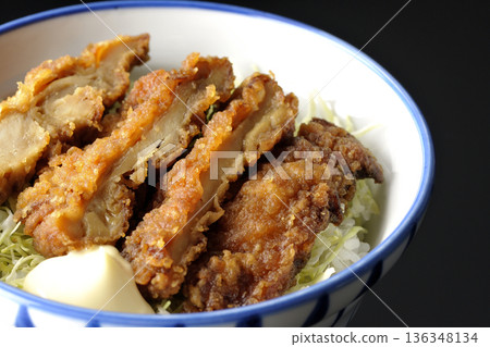 Mayonnaise and fried chicken rice bowl photographed against a black background Mayonnaise and fried chicken rice bowl photographed against a black background 136348134