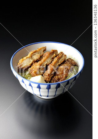 Mayonnaise and fried chicken rice bowl photographed against a black background 136348136