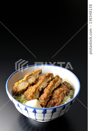 Mayonnaise and fried chicken rice bowl photographed against a black background Mayonnaise and fried chicken rice bowl photographed against a black background 136348138