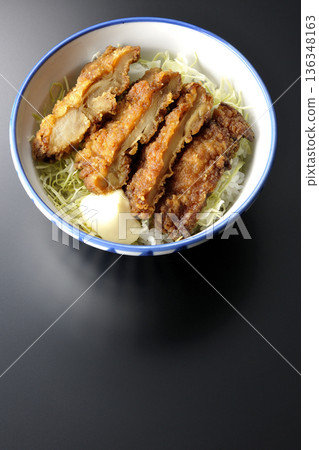 Mayonnaise and fried chicken rice bowl photographed against a black background 136348163