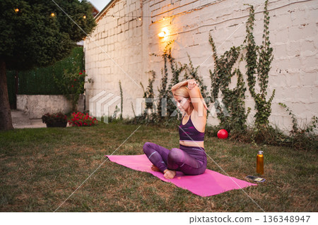 Empowered mother embraces fitness journey in garden after childbirth 136348947