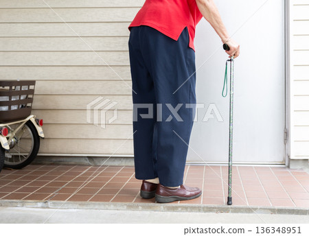 Hands and lower body of a senior woman using a cane outdoors Elderly image 136348951