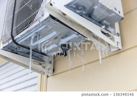 Icicles on the outdoor unit of an air conditioner Icicles on the outdoor unit of an air conditioner 136349148