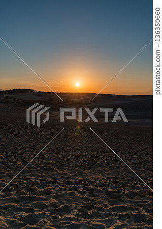 Sunset seen from Tottori Sand Dunes, one of Japan's three major sand dunes, located in Fukube-cho, Tottori City, Tottori Prefecture, Japan Sunset seen from Tottori Sand Dunes, one of Japan's three major sand dunes, located in Fukube-cho, Tottori City, Tottori Prefecture, Japan 136350660