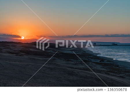 The Sea of Japan and the setting sun seen from the Tottori Sand Dunes in Fukube-cho, Tottori City, Tottori Prefecture, Japan The Sea of Japan and the setting sun seen from the Tottori Sand Dunes in Fukube-cho, Tottori City, Tottori Prefecture, Japan 136350678