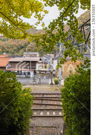 Ikuyama Shrine with its railroad tracks and autumn leaves in Nichinan Town, Hino District, Tottori Prefecture, Japan 136350885