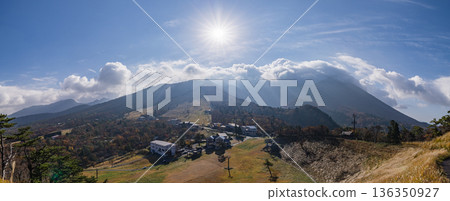 The autumn leaves of Mt. Daisen illuminated by the sun as seen from Mount Goen Noroshidai in Daisen Town, Saihaku District, Tottori Prefecture, Japan 136350927