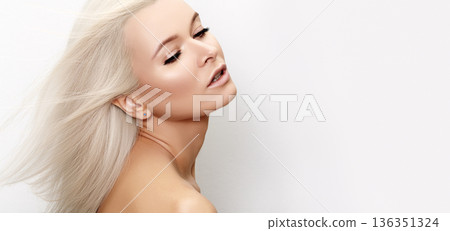 Woman with Bright Flowing Platinum Hair. Energized Shot Luminous Skin And Flawless Platinum Tresses. Vivid Model Of Shimmering Platinum Locks And Luminous Skin, Long Hair in Natural Wind, Beauty 136351324
