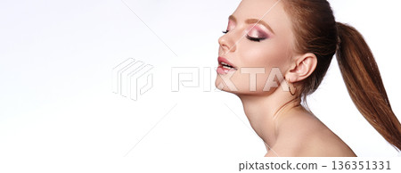 Peaceful Radiant Woman. Calm Beauty With Shimmering Eyes. Serene Lady With Glowing Skin And Elegant Hair. Relaxed Female Model Showcasing Luminous Complexion And Subtle Makeup, Ponytail Hairstyle 136351331