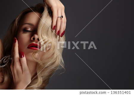 Sophisticated Caucasian Woman With Bright Red Nail Polish And Curly Blonde Hair. Refined Portrait Of Elegant Woman With Vibrant Red Nails And Curly Blonde Hair Adorned With Jewelry Sophisticated Caucasian Woman With Bright Red Nail Polish And Curly Blonde Hair. Refined Portrait Of Elegant Woman With Vibrant Red Nails And Curly Blonde Hair Adorned With Jewelry 136351401