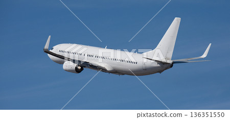 Airplane take off on the blue sky, with white clouds. Aircraft flying on sky background. White passenger jet plane in the blue sky. Undercarriage retracted Airplane take off on the blue sky, with white clouds. Aircraft flying on sky background. White passenger jet plane in the blue sky. Undercarriage retracted 136351550