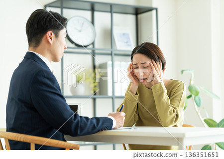 A middle-aged woman who consults with her worries A middle-aged woman who consults with her worries 136351651